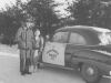 A3C Red Ross and somebody's daughter standing beside an OPPs squad car - January 1953.
